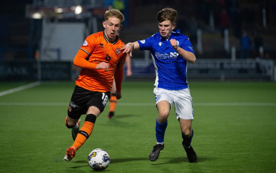 Dundee United winger Kai Fotheringham surges past Queens' Oscar MacIntyre.