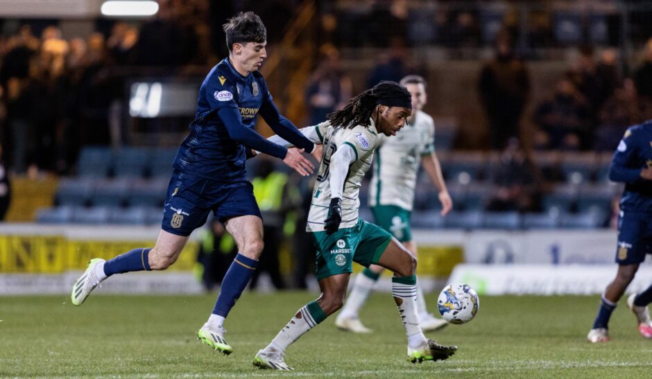 Charlie Reilly takes on Hibs. Image: SNS