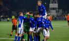 Queen of the South players celebrate their victory over Dundee United