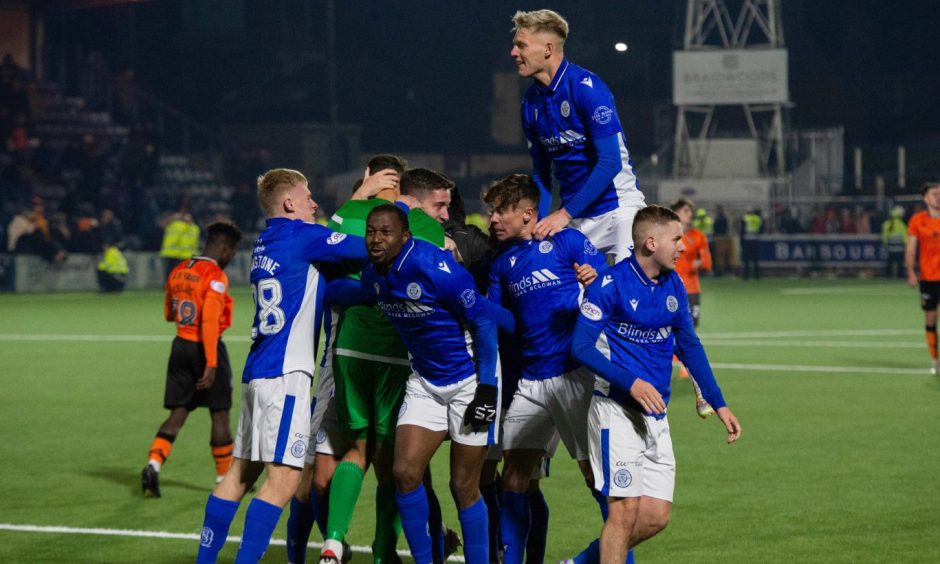 Queen of the South players celebrate their victory over Dundee United