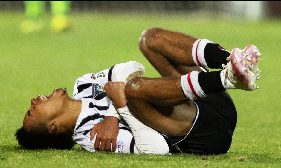 Kane Ritchie-Hosler writhes in agony after dislocating his shoulder in Dunfermline's recent 3-0 win against Arbroath. Image: SNS.