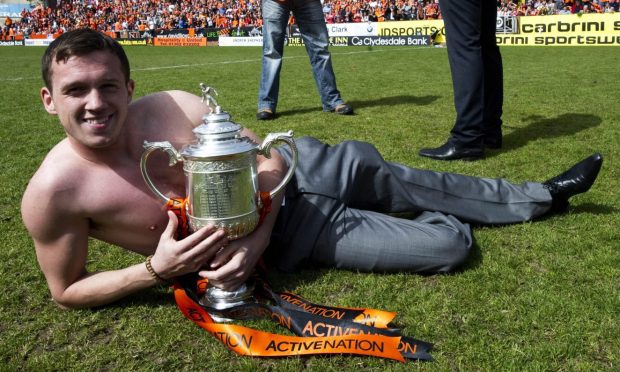 Former Dundee United man Danny Swanson clutches the Scottish Cup on the Tannadice turf, the day after defeating Ross County