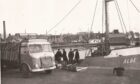 The lorry in this picture from Arbroath Harbour in 1955 has a Liverpool registration but was operated by the Panmure Trading Company in Monikie. Image: Supplied.