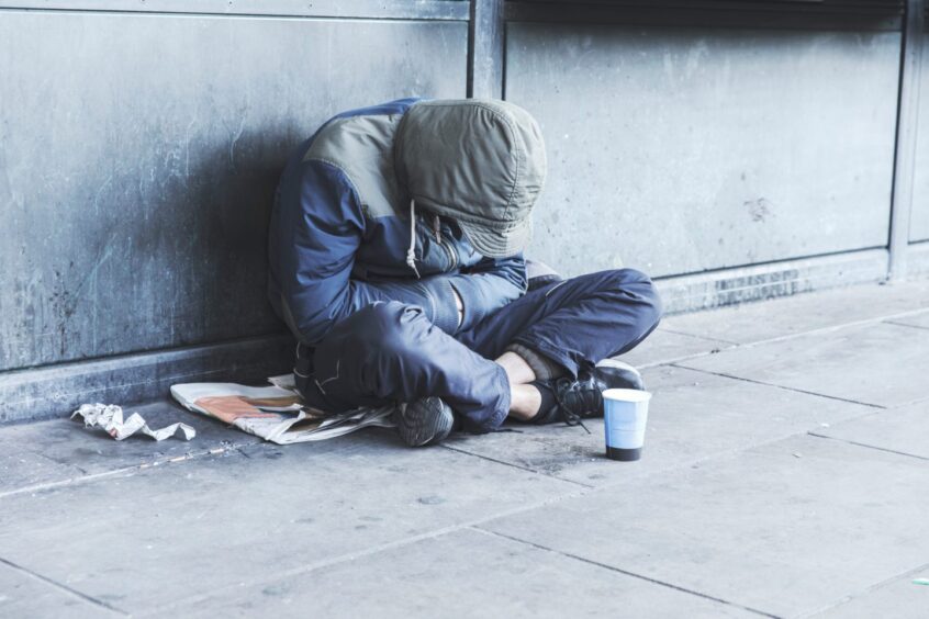 A homeless person on the street.