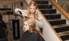 Chloe Knox works on fellow S4 pupil Rebecca Paterson's hair in Lime Salon.