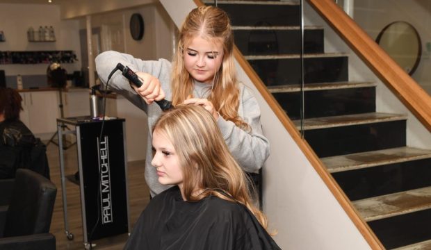 Chloe Knox works on fellow S4 pupil Rebecca Paterson's hair in Lime Salon.