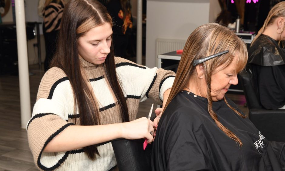 Former Beath High School pupil Kasey Coutts working on a client's hair at Lime Salon. 