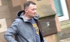 Daniel Clark leaves Forfar Sheriff Court after being banned.