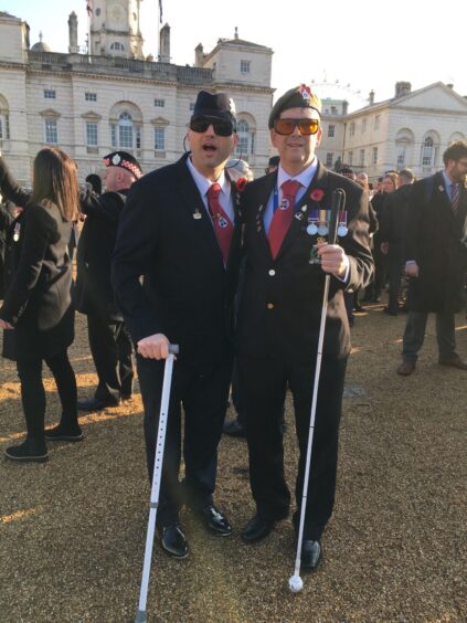 Aber (right) outsideBuckingham Palace