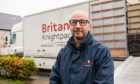 Managing director Scot Brown with one of the Britannia Knightpacking lorries. Image: Kim Cessford/DC Thomson.