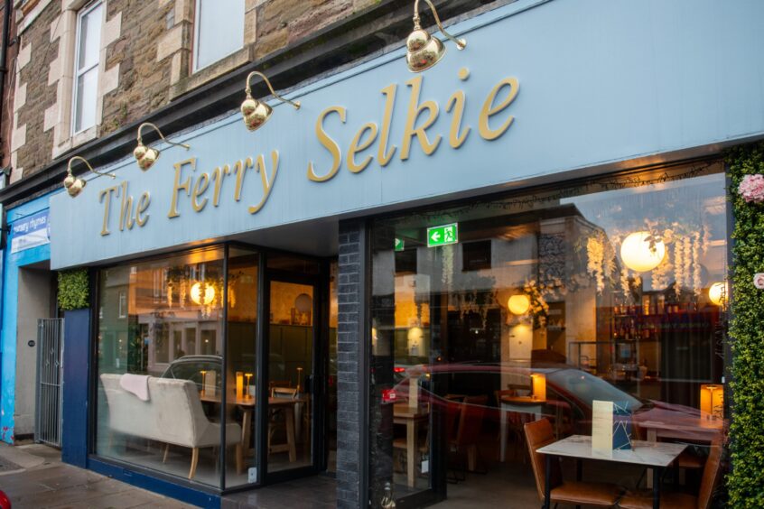 The outside of The Ferry Selkie with huge windows showing the inside