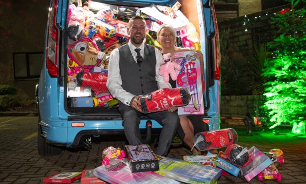 Gary Rooney and charity manager Stacey Wallace with the vanload of toys. Image: Kim Cessford/DC Thomson.