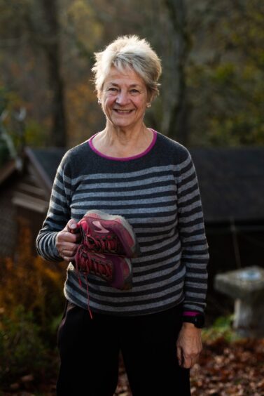 Lesley Richardson holding running shoes