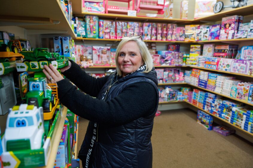 Image shows: Anita Stewart, owner of Toymaster in Broughty Ferry setting the shelves straight for Christmas.