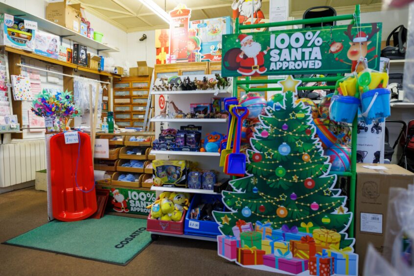 Image shows the interior of The Nappy Pin and Toymaster in Broughty Ferry. The shop is stocked and decorated for Christmas.