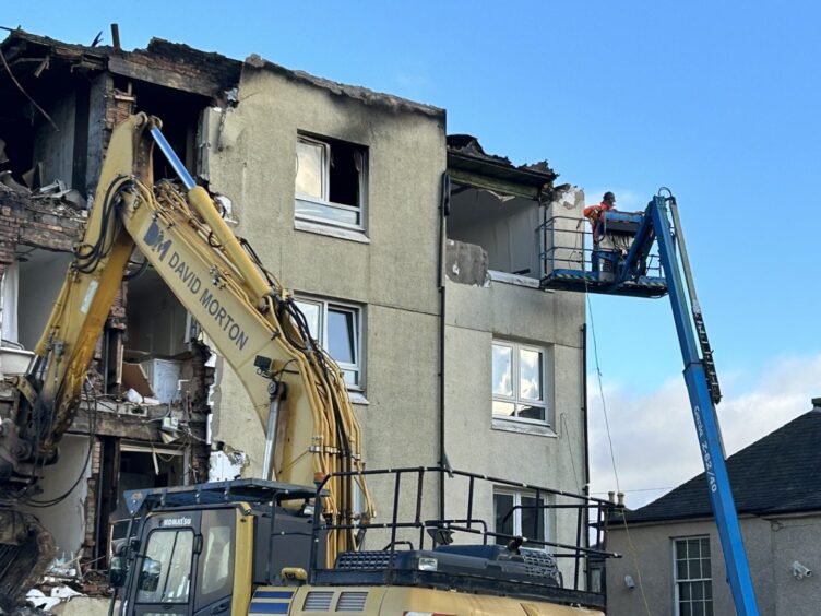 Demolition experts assess the damage. 