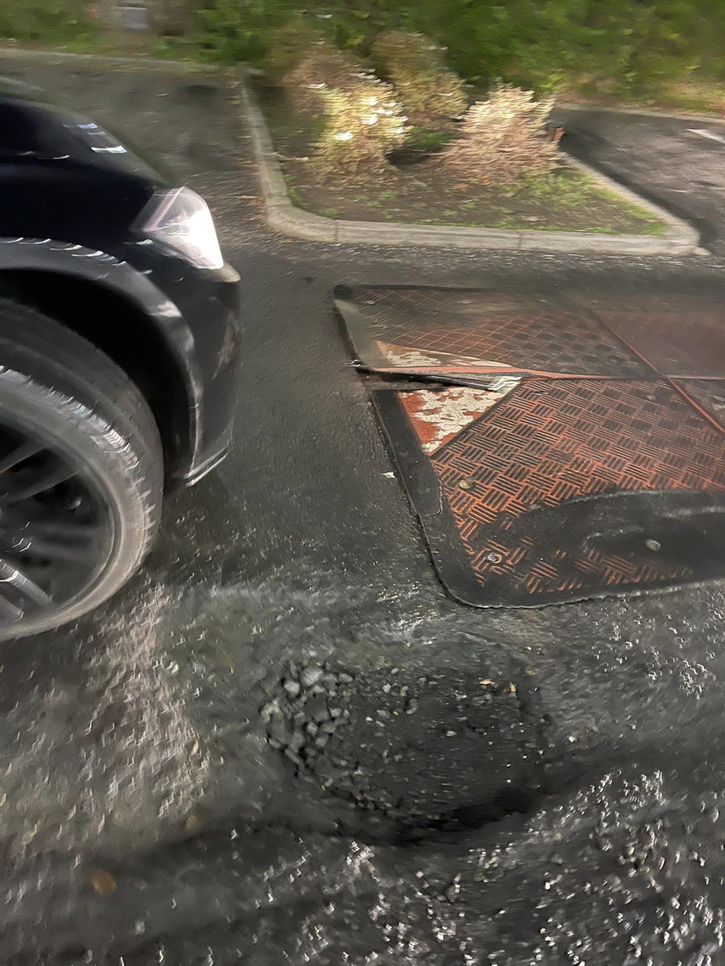 The bumper of Louise's car wedged into a speed bump.