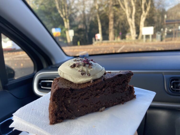 A food review of Aran Bakery in Dunkeld, photographed is the chocolate brandy and rye tort with cream on top on a napkin.