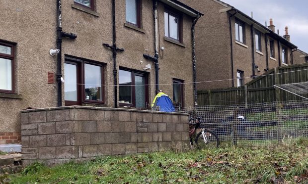 Police erected a blue tent outside a house in Brownhill Road, Charleston, Dundee.