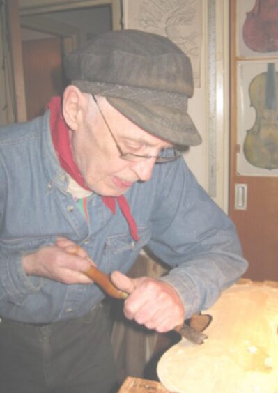 Ian Ross working on a fiddle in his studio in later life.