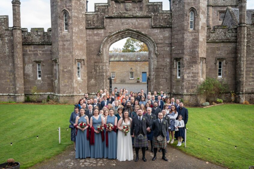 Newlyweds Claire and Alasdair Macdonald with their wedding party at Abercairny Estate
