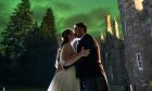 Newlyweds - Claire and Alasdair Macdonald with the Northern Lights.