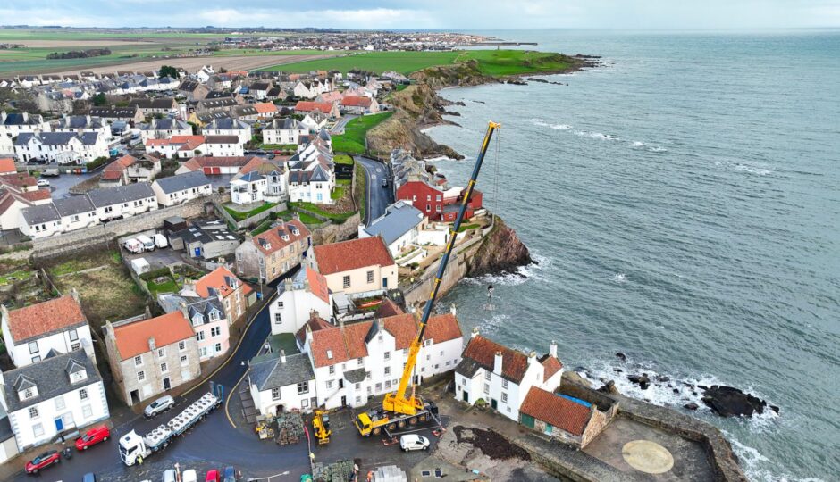 The crane towers above Pittenweem houses.