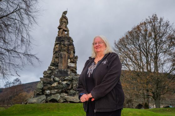 Val Ferguson standing next to the Black Watch monument in Aberfeldy.
