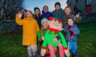 At the front is Kerry McBain (Illuminations Committee) with Elfred and back row, left to right is 
Amelia Strachan (aged 7), Ella Strachan (aged 11), Fia Tennant (aged 10), Nathan MacLeod (aged 12), James Tennant (aged 7) and Micah MacLeod (aged 3) Image: Steve MacDougall/DC Thomson