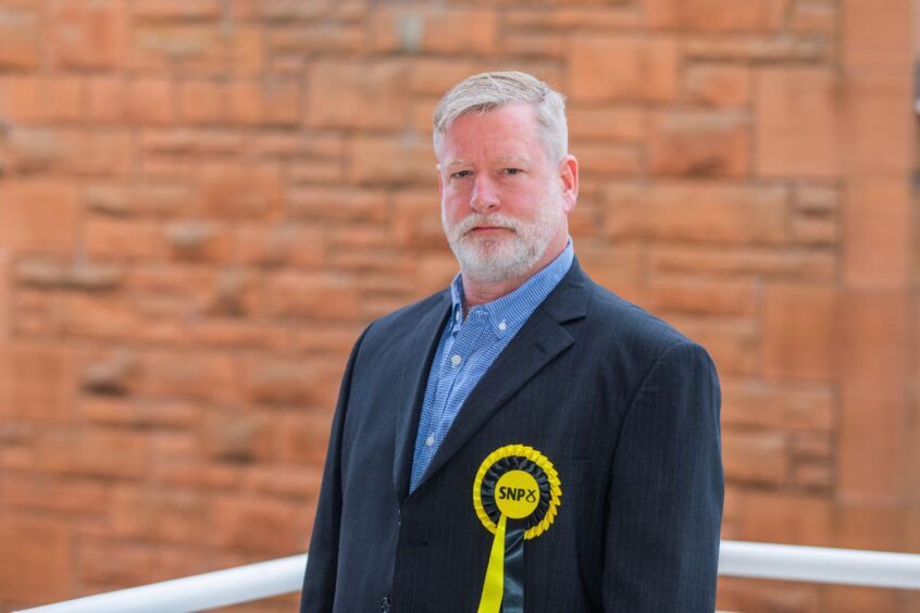 Councillor Steve Carr wearing SNP rosette