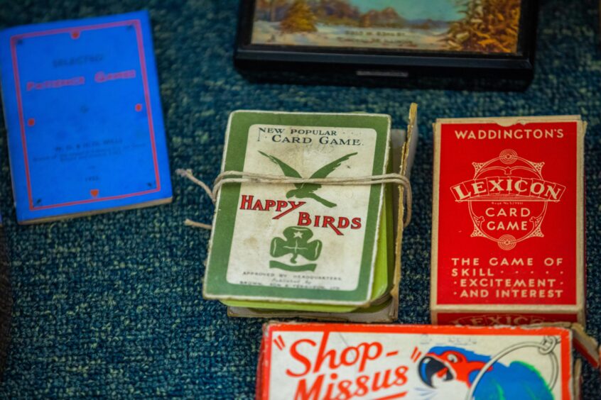 Old fashioned playing cards, games and a book which once belonged to Martin Boyle