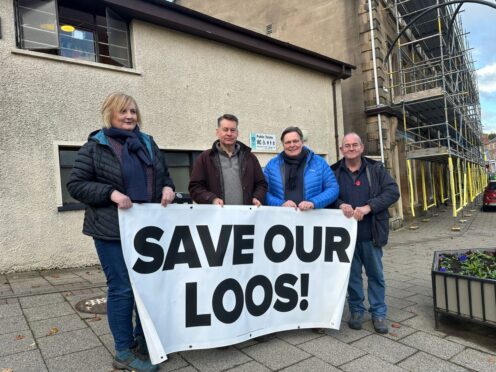 Councillor Caroline Shiers, Murdo Fraser MSP, Stephen Kerr and Councillor Bob Brawn with a Save Our Loos banner outside the public toilet block in Blairgowrie