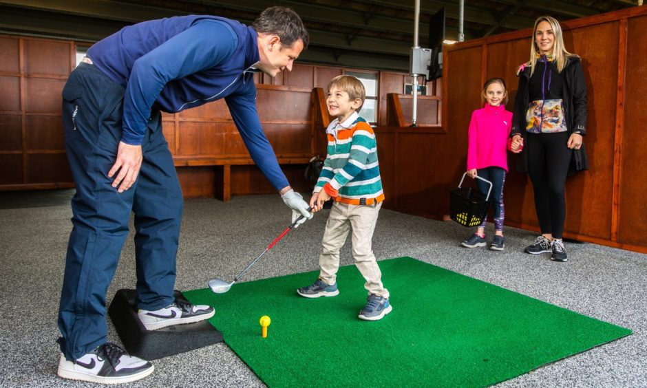 Arlo, 4, gets a lesson from dad at St Andrews Links Academy.