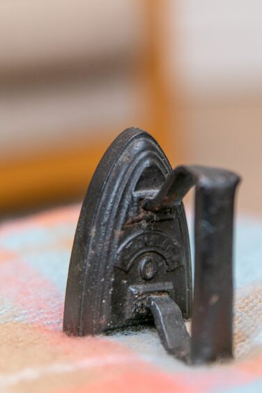 Image shows a miniature iron owned by Beth Baxter dating from c1900. The iron was heated on the range and used to smooth hair ribbons.