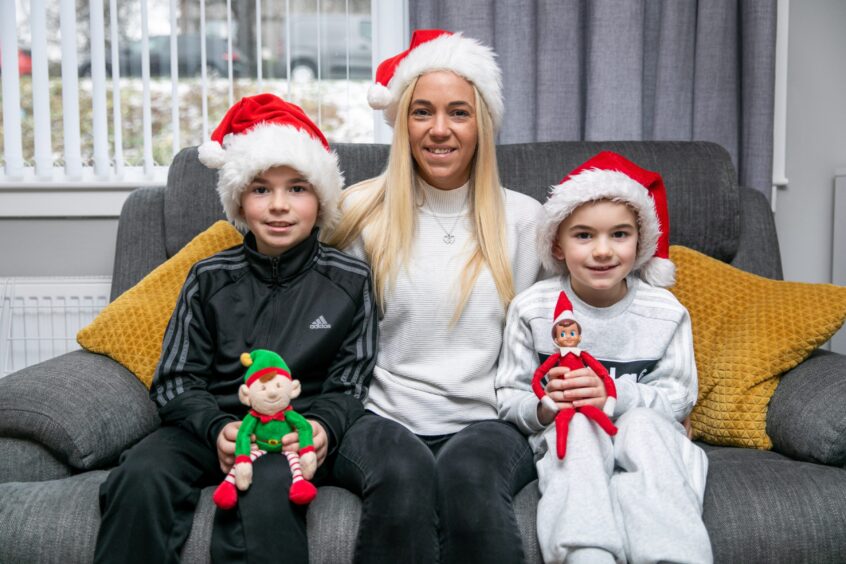 Tommi and Lochlan with mum Stacey Campbell and their Christmas elves.