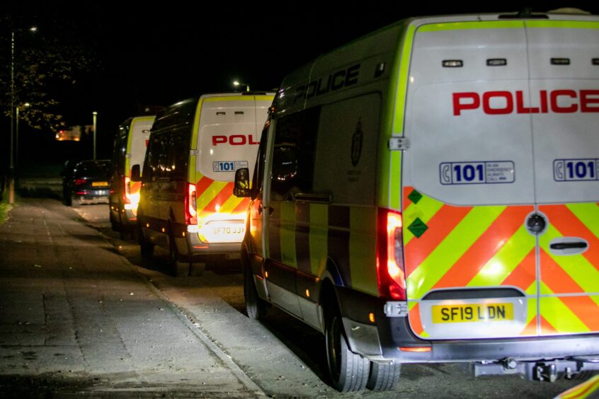 Police vans at the scene of the riots. 