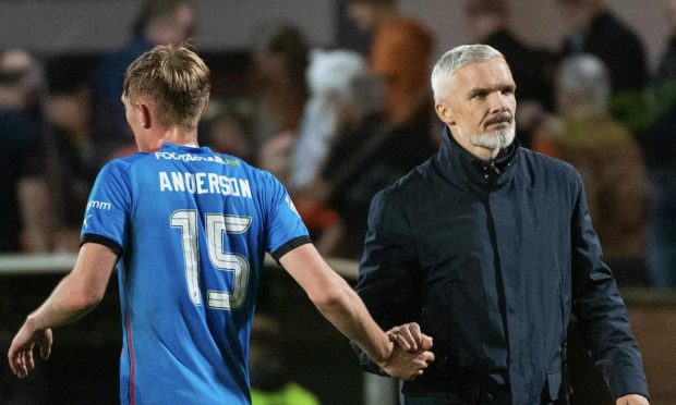 Dundee United boss Jim Goodwin shakes hands with on-loan Dundee midfielder Max Anderson