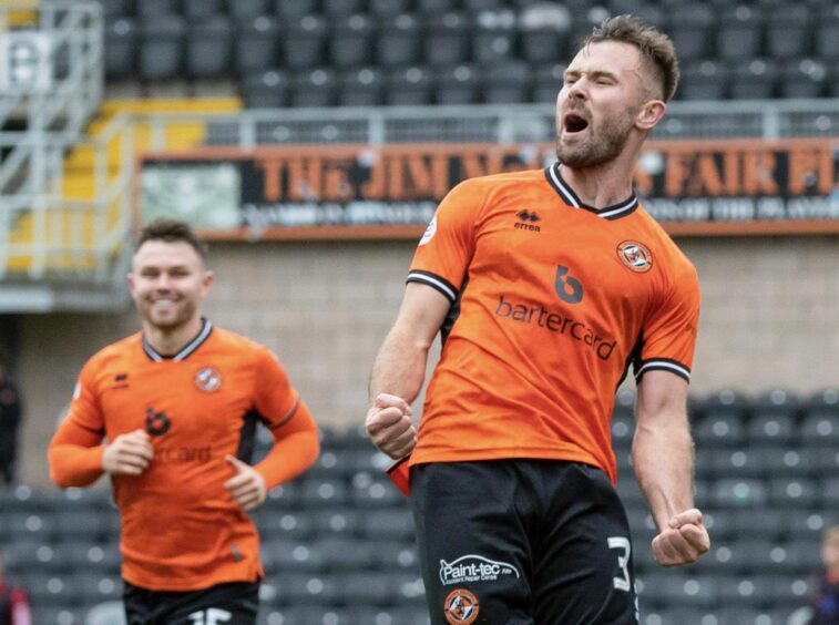 Scott McMann celebrates finding the net for Dundee United