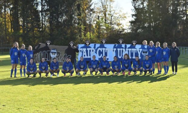 Members of St Johnstone fans' group Fair City Unity wth Saints Women stars in their new training kit. Image: Stuart Cowper