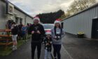 Family in Santa hats at Zenith Fitness Training charity van pull
