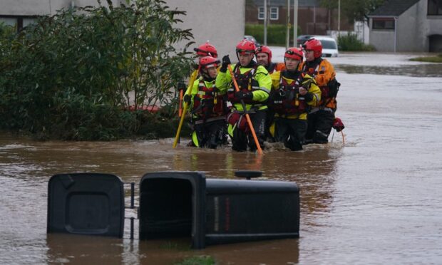 Rescuers in River Street during Storm Babet Image: PA