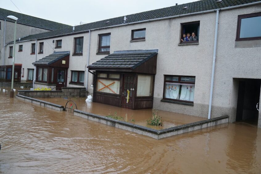 Floodwater outside Laura's home in Brechin. The water is halfway towards the front door handle.