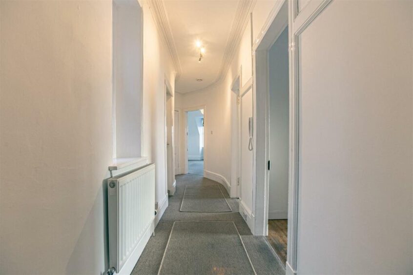 A curved hallway leads through the flat.