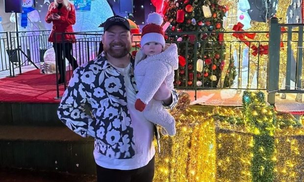 Cammy Barnes with daughter Bonnie when he switched on the Christmas lights at Five Sisters Zoo in West Lothian. Image: Cammy Barnes