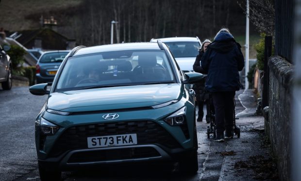 Barbara Sturrock trying to pass a car parked on a pavement whilst on the school run. Image: Mhairi Edwards/DC Thomson.