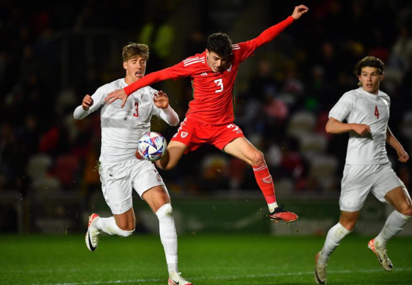 Owen Beck takes on Denmark for Wales U/21s. Image: Ben Evans/Huw Evans/Shutterstock