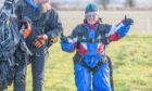 Irene Cattanach smiling on the ground at the end of her charity skydive