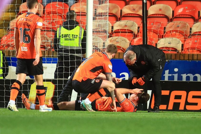 Declan Gallagher receives treatment for Dundee United. 