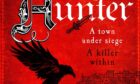 Image shows the cover of historical novel Dark Hunter by F J Watson. The book cover is a deep red with gothic style script and an image of a black bird coming in to land.