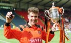 Former Dundee United star Craig Brewster clutches the Scottish Cup
